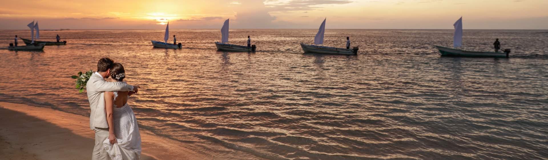 Wedding couple on the beach at sunset